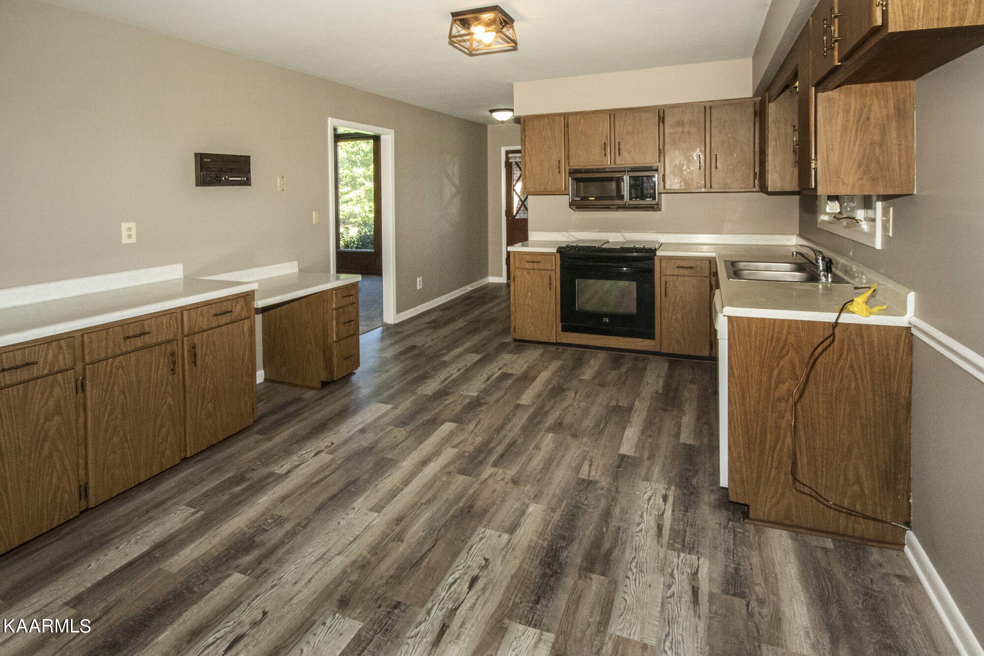 431 Sunnyside Road Sweetwater, TN 37874 - Photo 14 of 47 a kitchen with wooden floors and stainless steel appliances