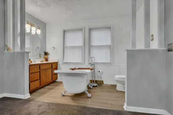 a bathroom with a sink toilet a mirror and bathtub