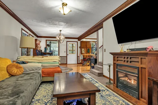 a living room with furniture a flat screen tv and a fireplace
