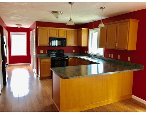 279 Stowell Road Ashburnham, MA 01430 - Photo 4 of 30 a kitchen with stainless steel appliances granite countertop a stove a sink and a microwave