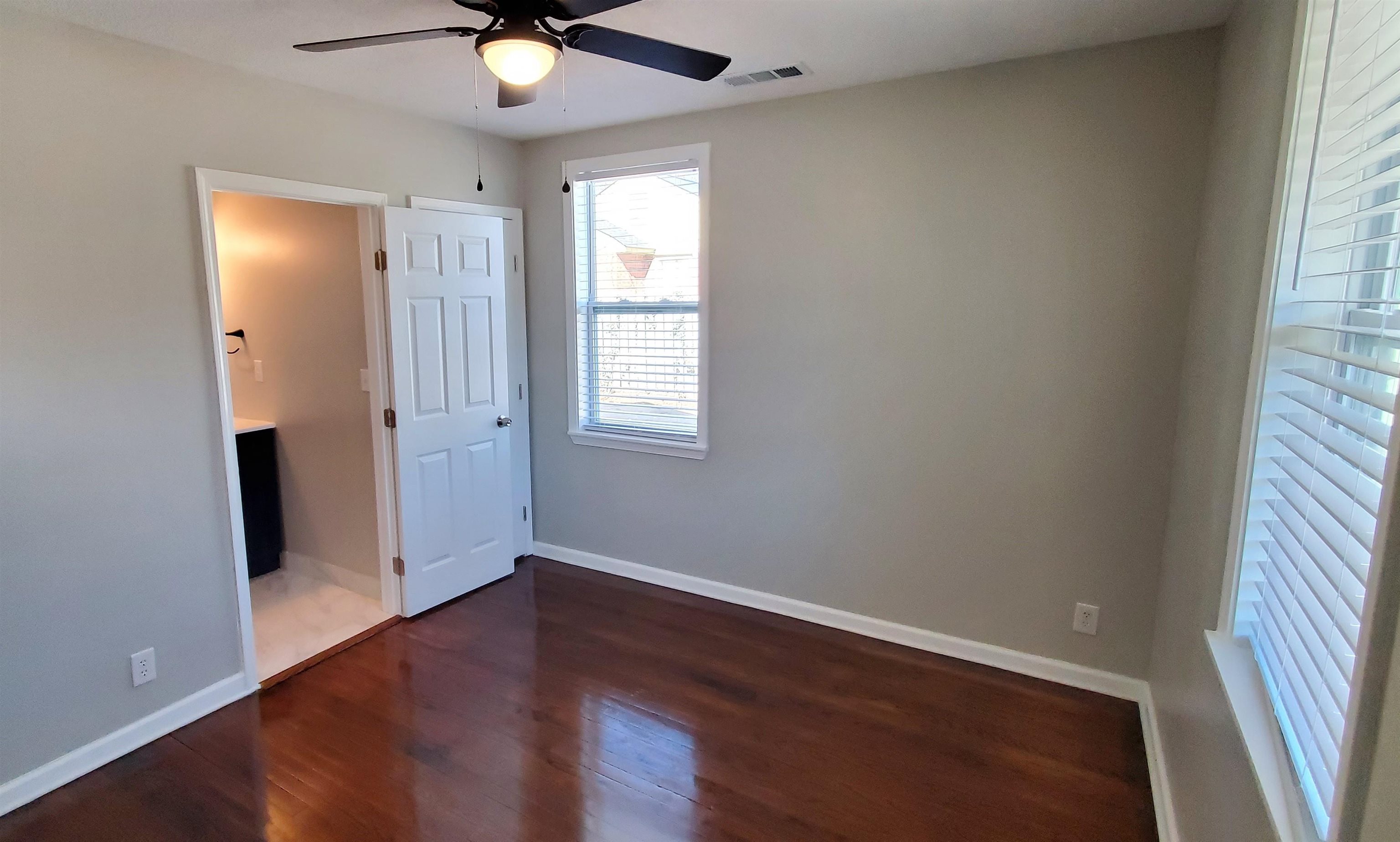 1077 Colonial Road Memphis, TN 38117 - Photo 11 of 20 an empty room with wooden floor and windows