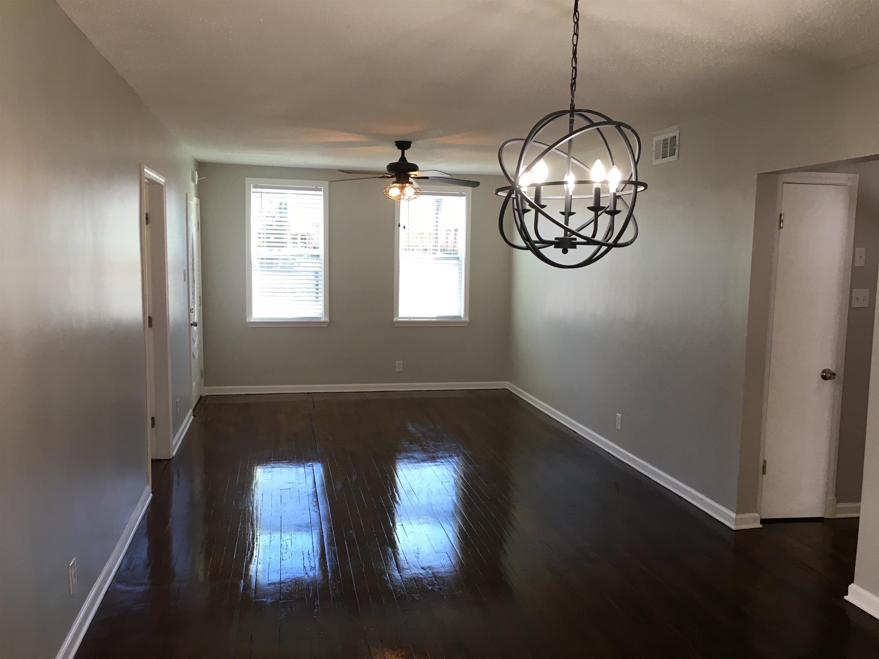 1077 Colonial Road Memphis, TN 38117 - Photo 4 of 20 a view of empty room with wooden floor and fan