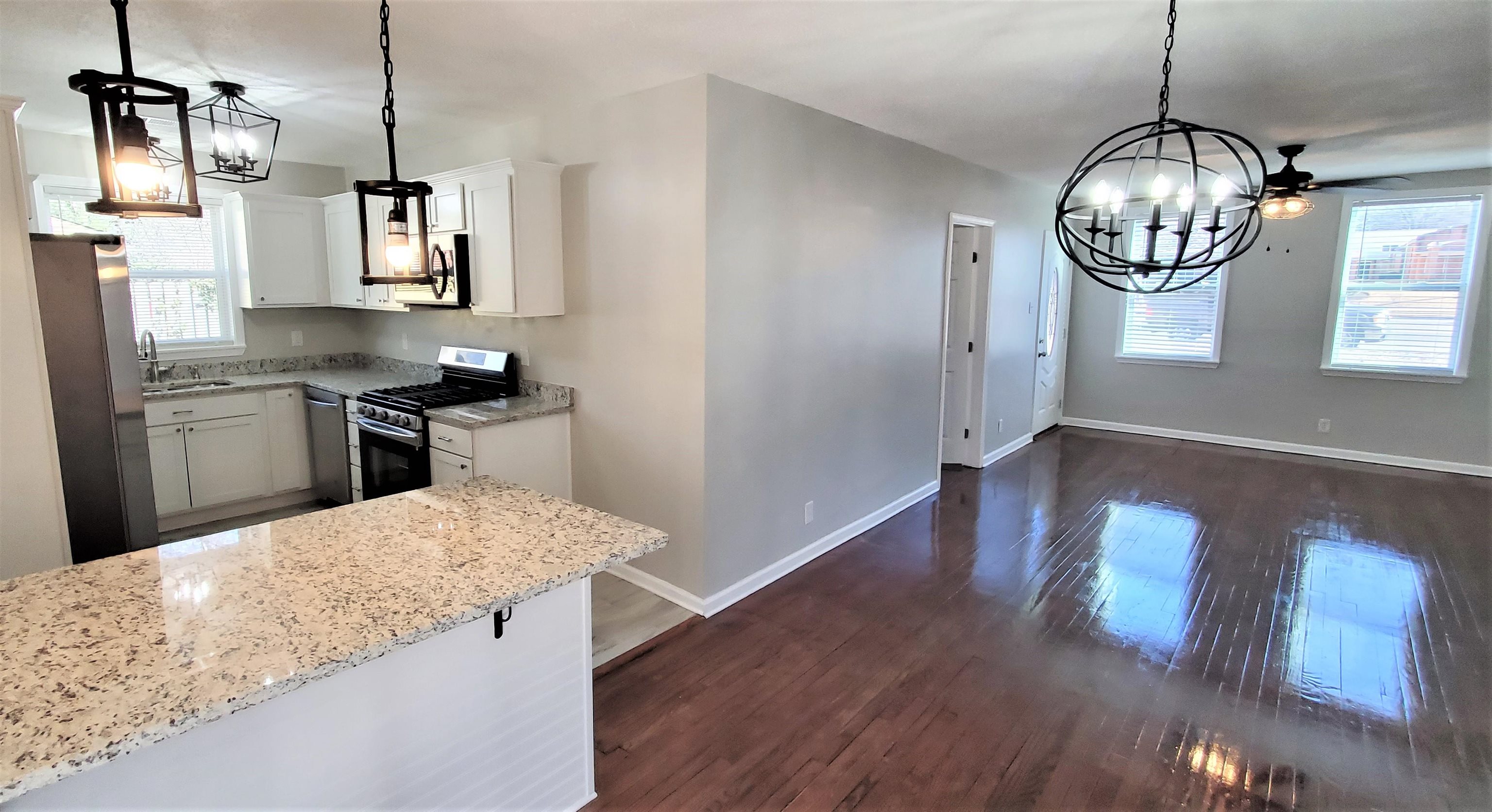 1077 Colonial Road Memphis, TN 38117 - Photo 10 of 20 a kitchen with wooden floor and window