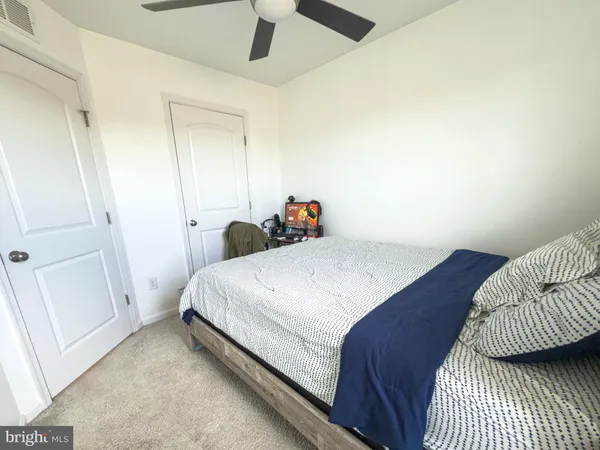 a view of a livingroom with wooden floor and a hallway