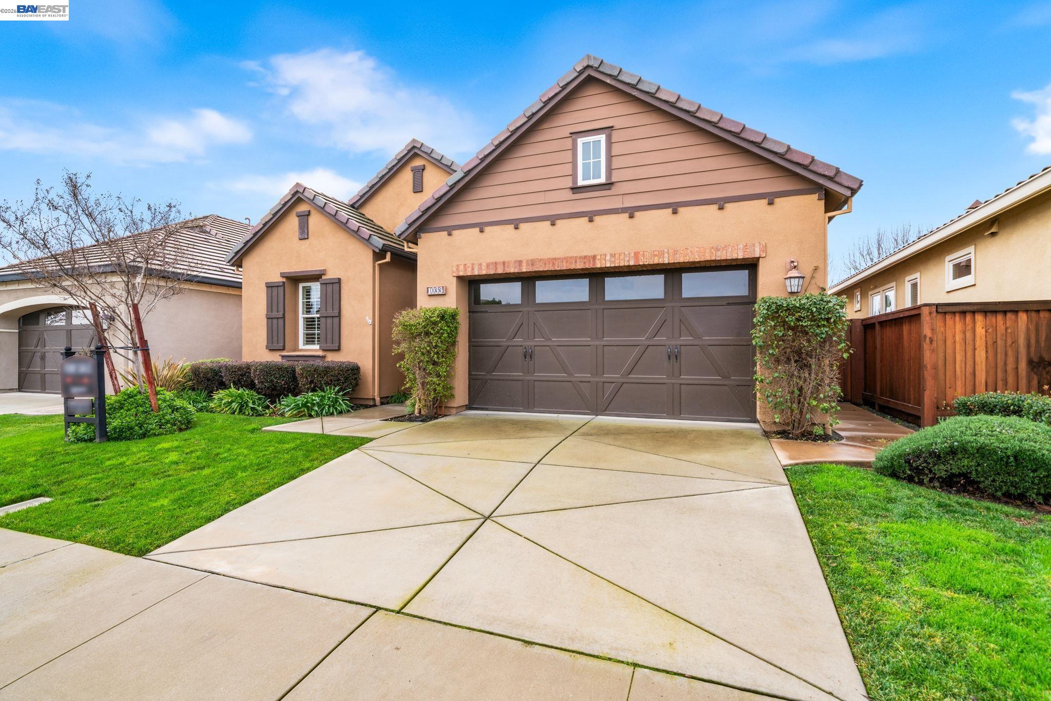 1033 Malbec Lane Brentwood, CA 94513 - Photo 2 of 37 a front view of a house with a yard and garage