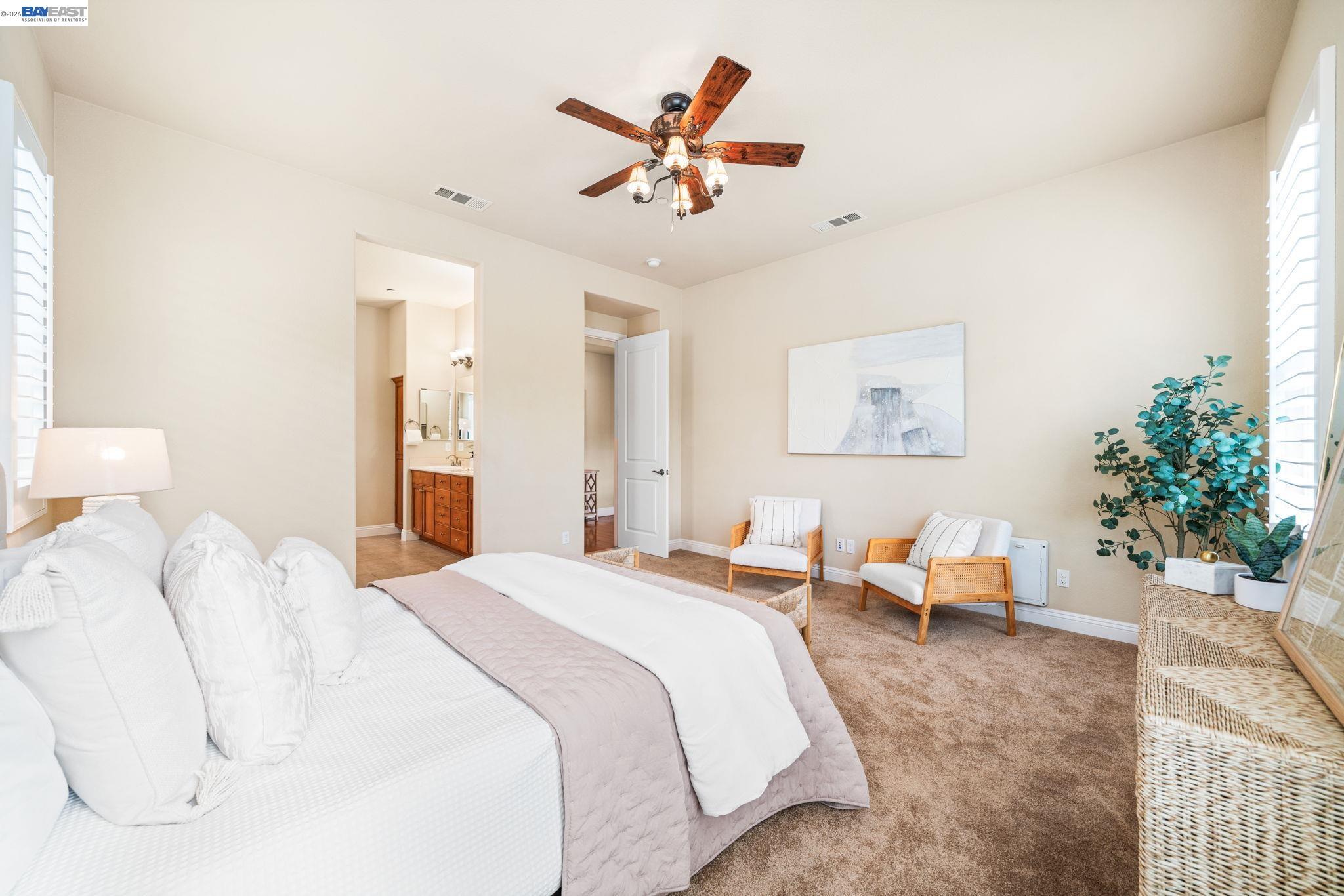 1033 Malbec Lane Brentwood, CA 94513 - Photo 23 of 37 a bedroom with a bed and a chandelier