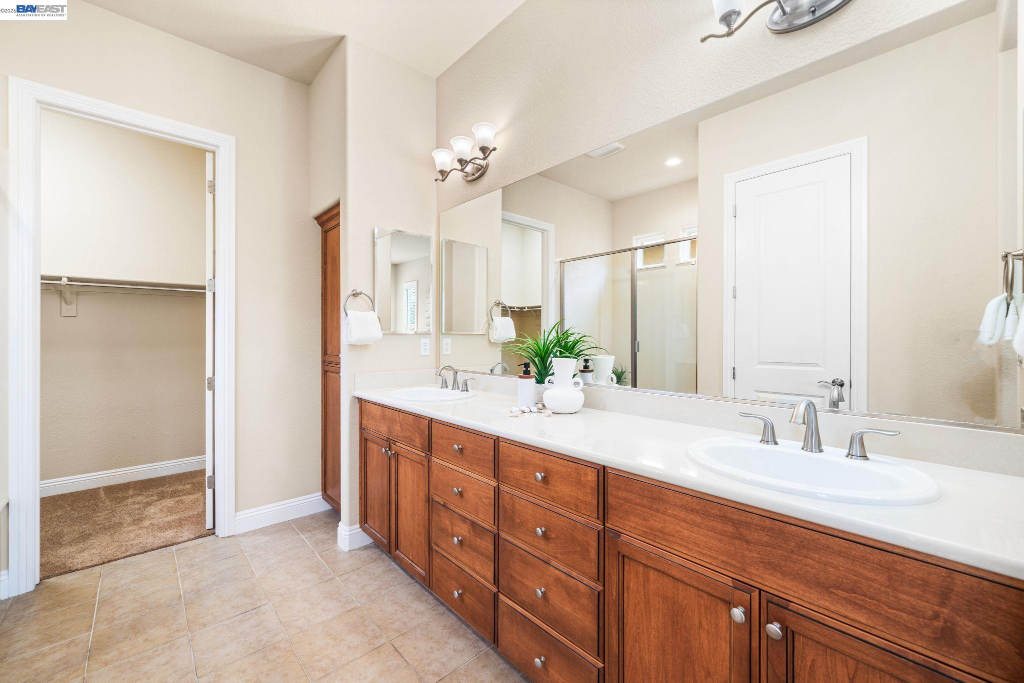 1033 Malbec Lane Brentwood, CA 94513 - Photo 24 of 37 a bathroom with double vanity sinks and a mirror
