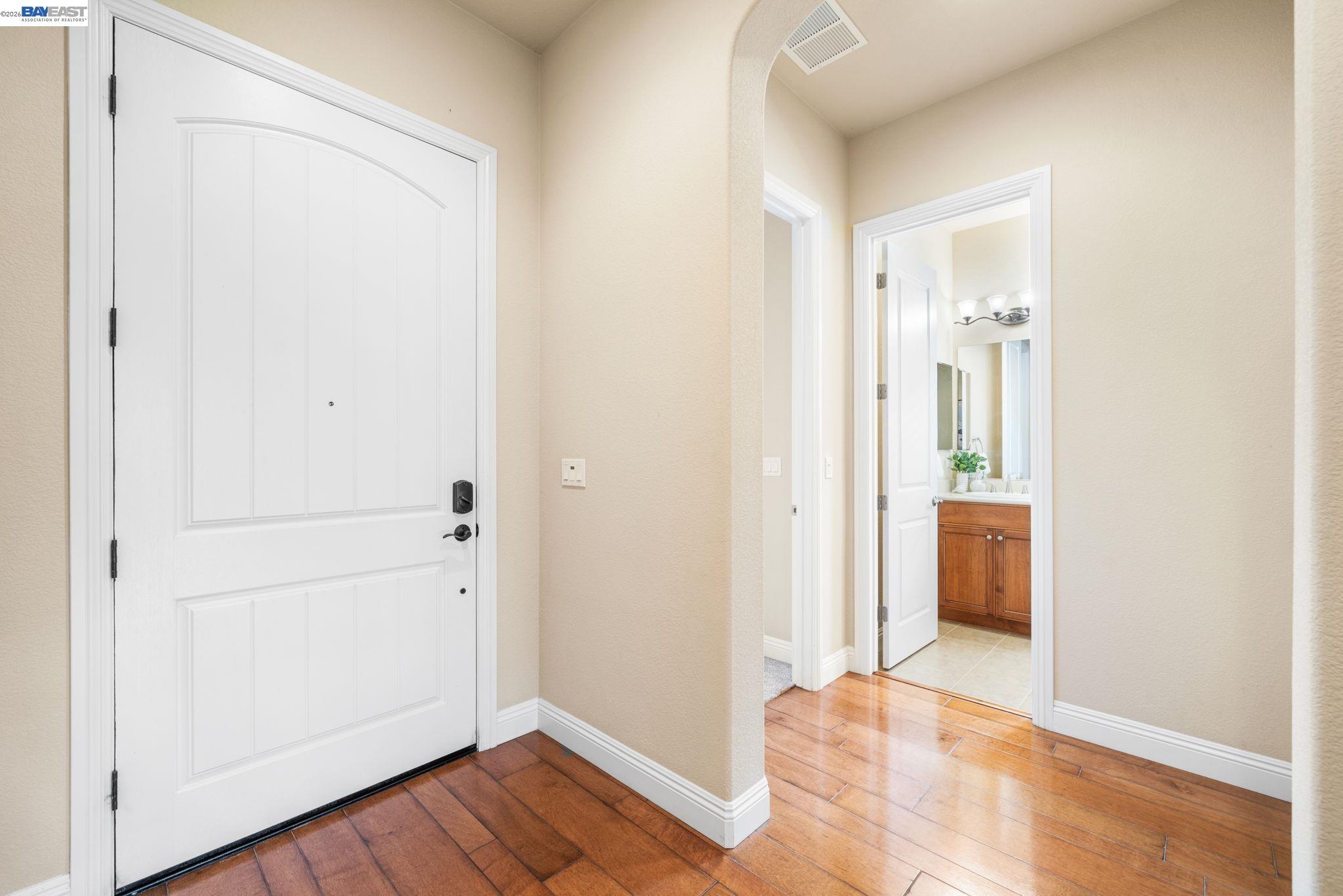 1033 Malbec Lane Brentwood, CA 94513 - Photo 4 of 37 a view of a hallway with wooden floor