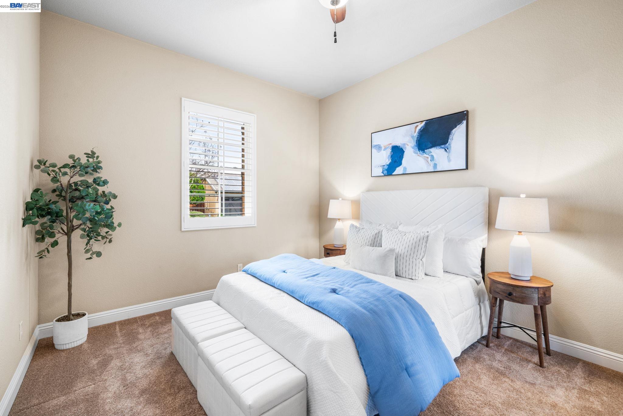 1033 Malbec Lane Brentwood, CA 94513 - Photo 6 of 37 a bedroom with bed and a potted plant