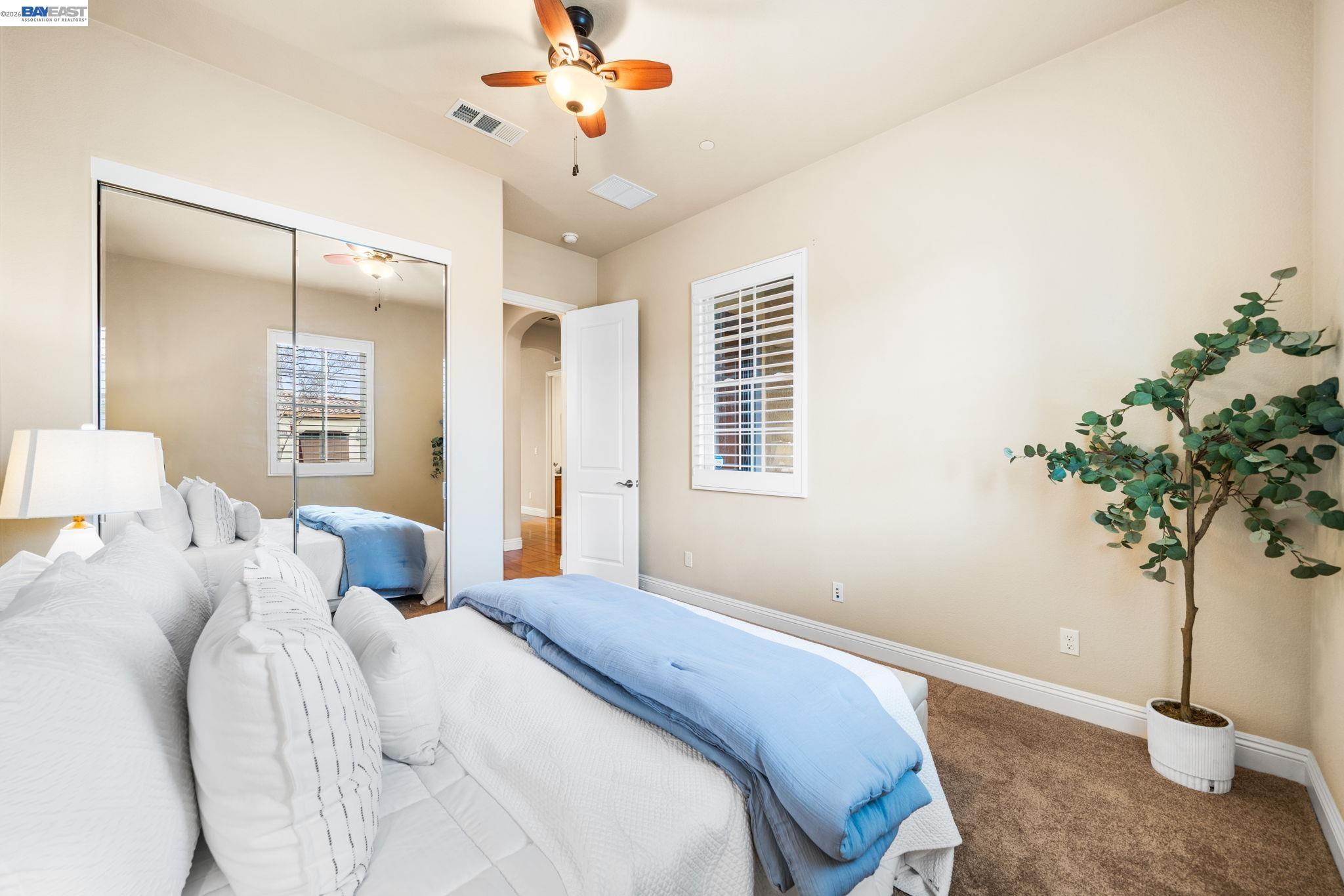 1033 Malbec Lane Brentwood, CA 94513 - Photo 7 of 37 a bedroom with a large bed and a chandelier