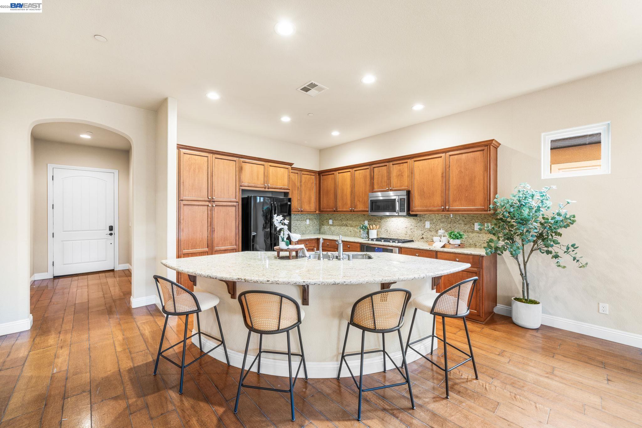 1033 Malbec Lane Brentwood, CA 94513 - Photo 10 of 37 a view of a dining room with furniture and a kitchen