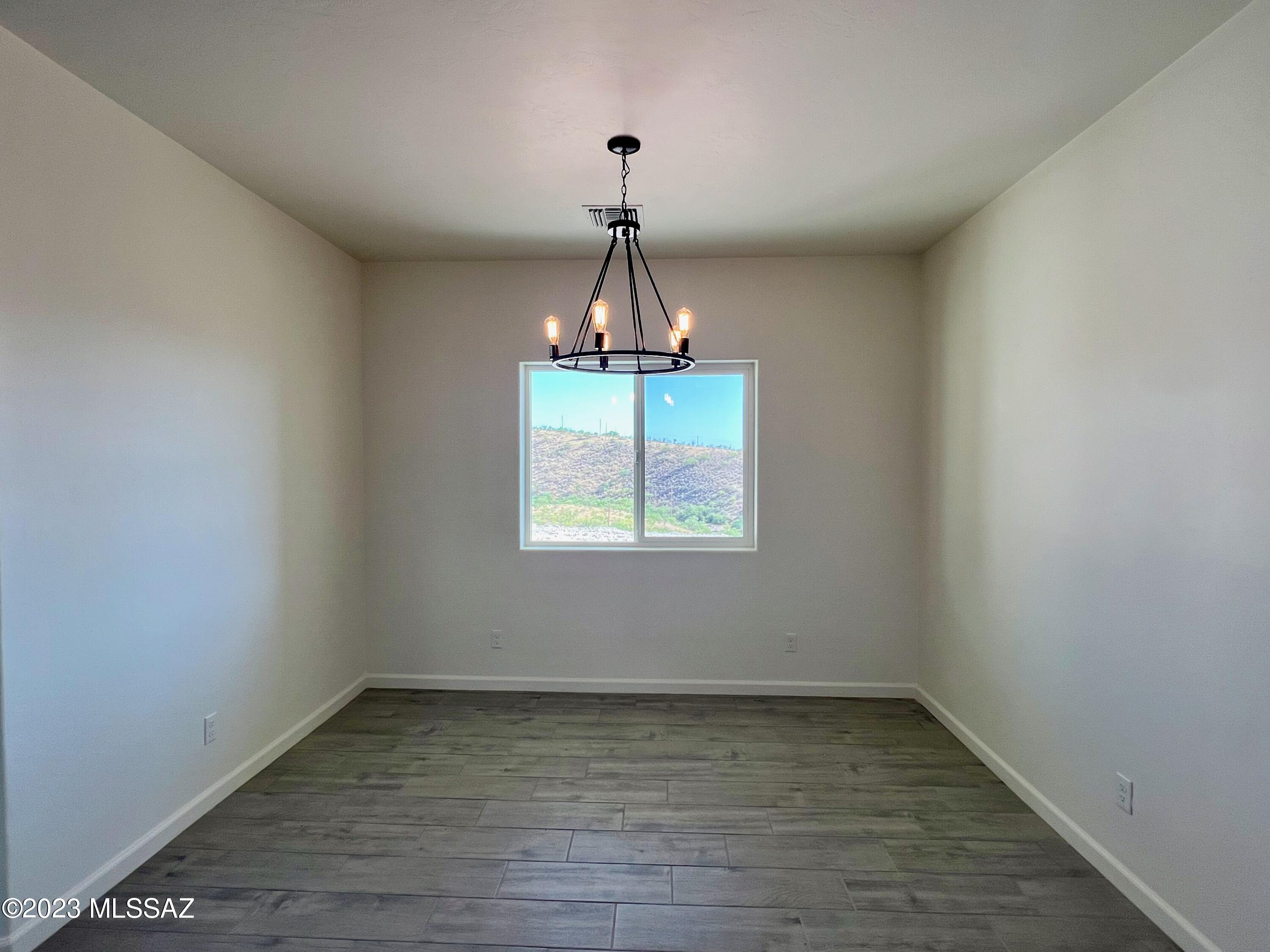 353 Dock Street Rio Rico, AZ 85648 - Photo 9 of 50 a view of a room with window and wooden floor