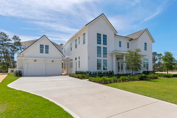 a front view of house with yard and green space