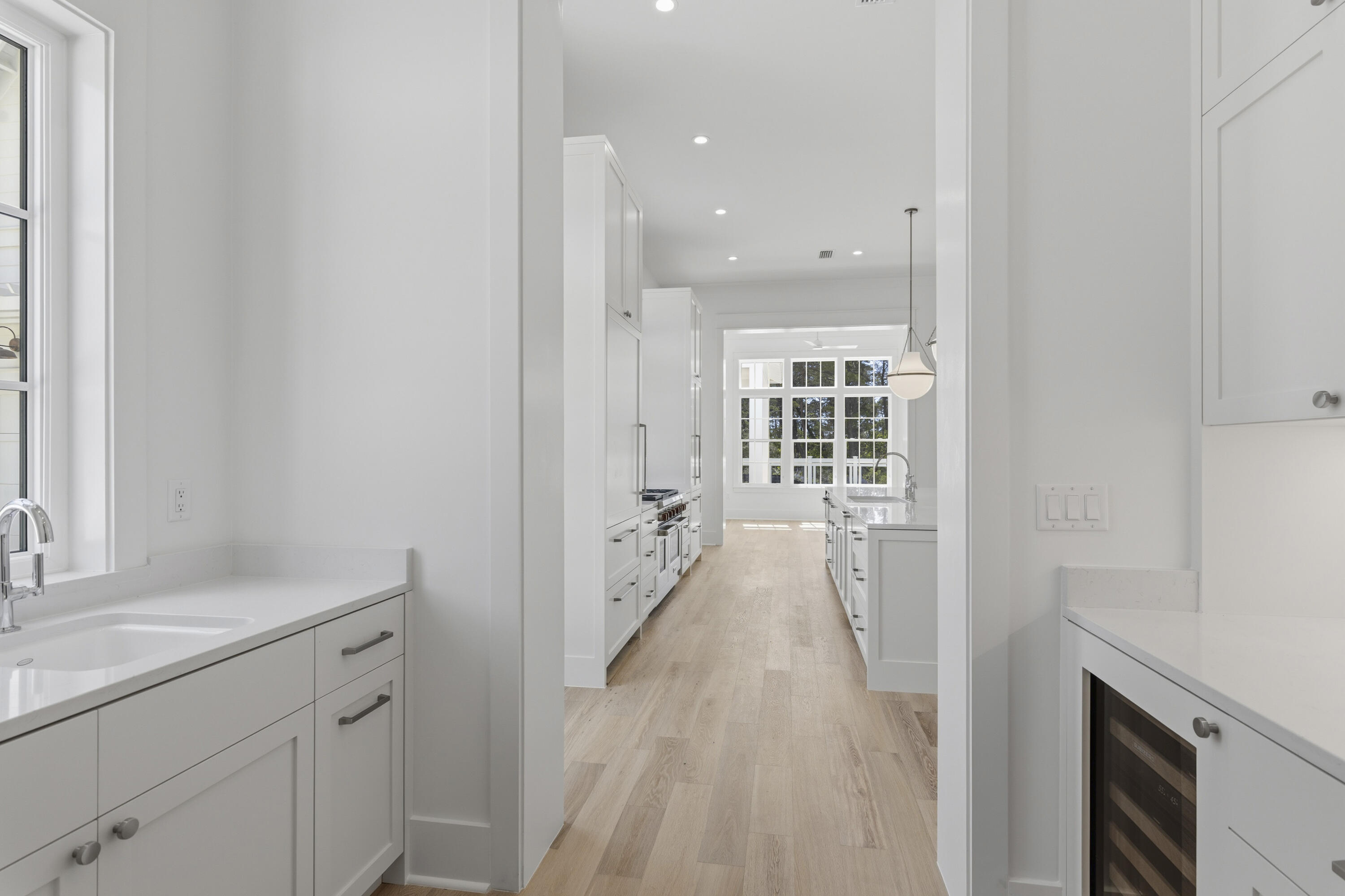 130 East Elliot Way Watersound, FL 32461 - Photo 12 of 52 a hallway with white cabinets and wooden floor