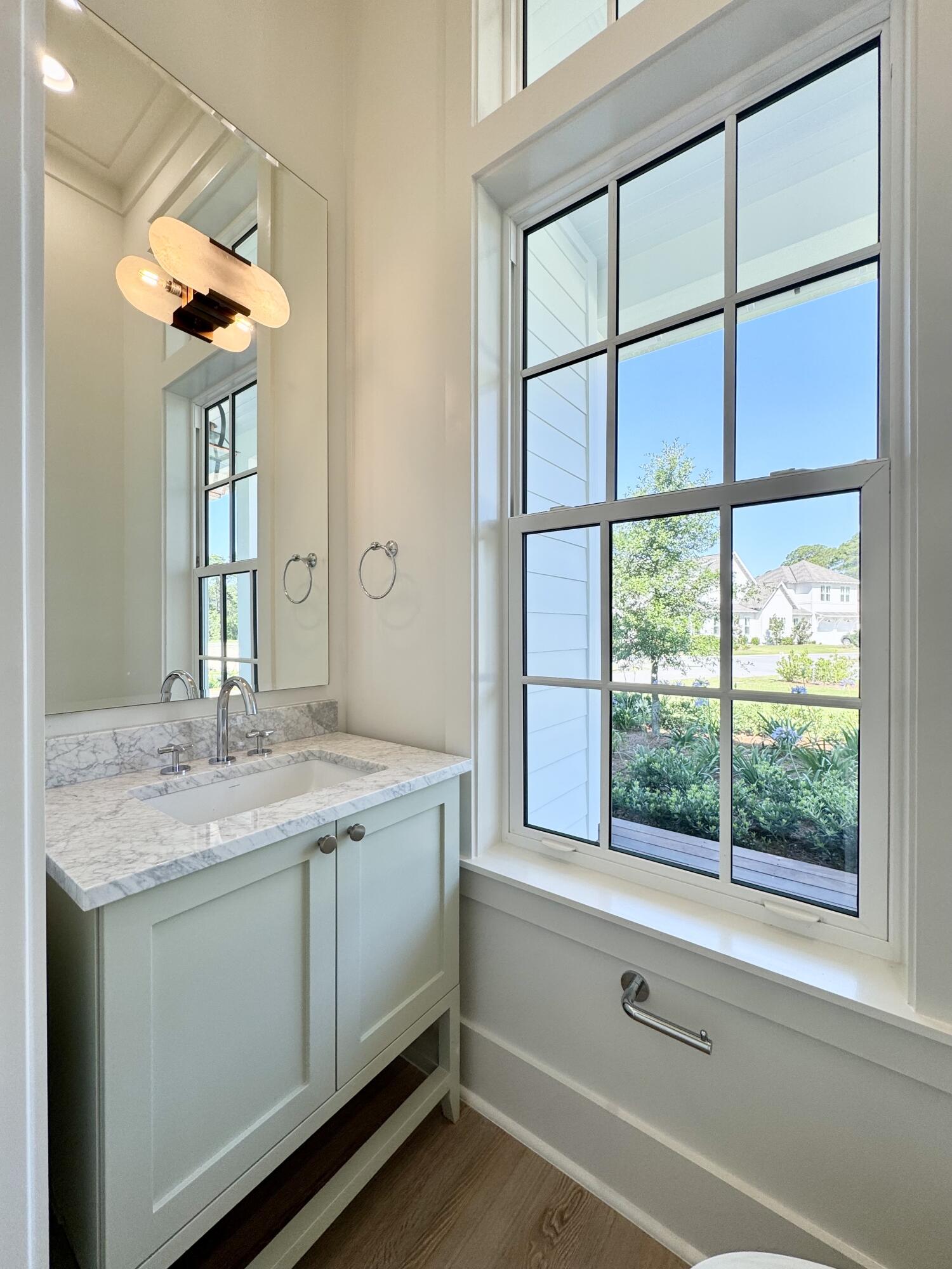 130 East Elliot Way Watersound, FL 32461 - Photo 14 of 52 a bathroom with a granite countertop sink and a window
