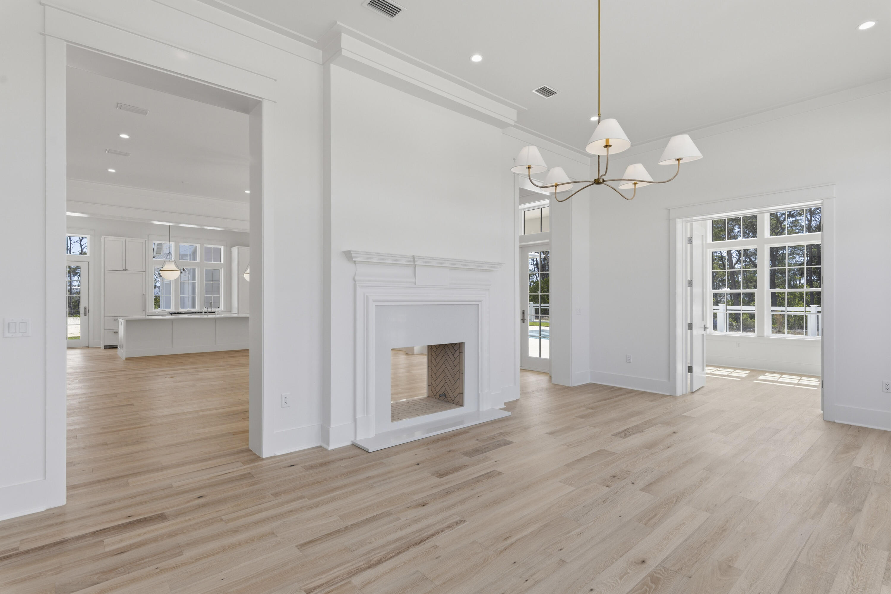 130 East Elliot Way Watersound, FL 32461 - Photo 22 of 52 an empty room with wooden floor fireplace and windows