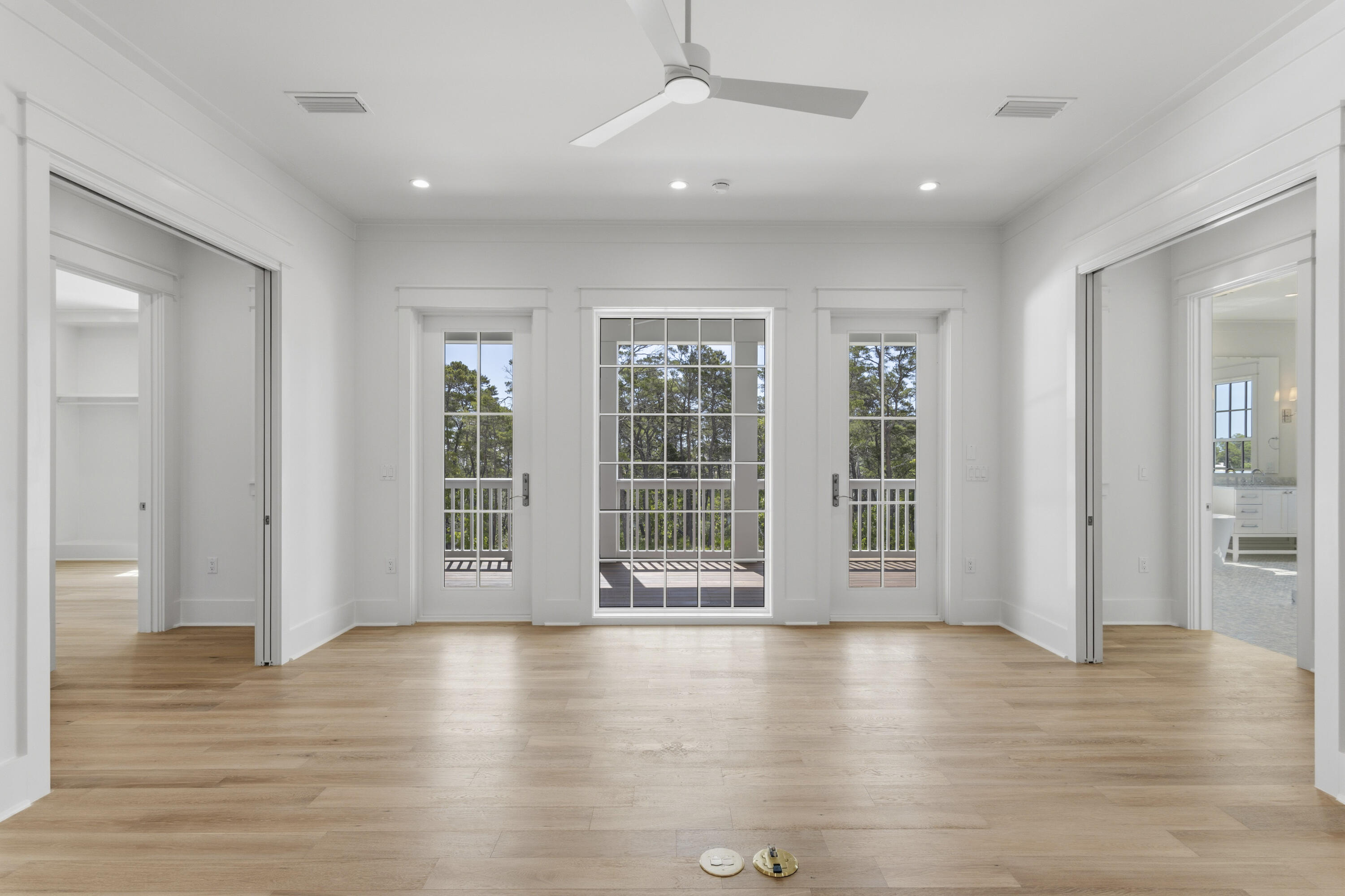 130 East Elliot Way Watersound, FL 32461 - Photo 28 of 52 an empty room with wooden floor and windows