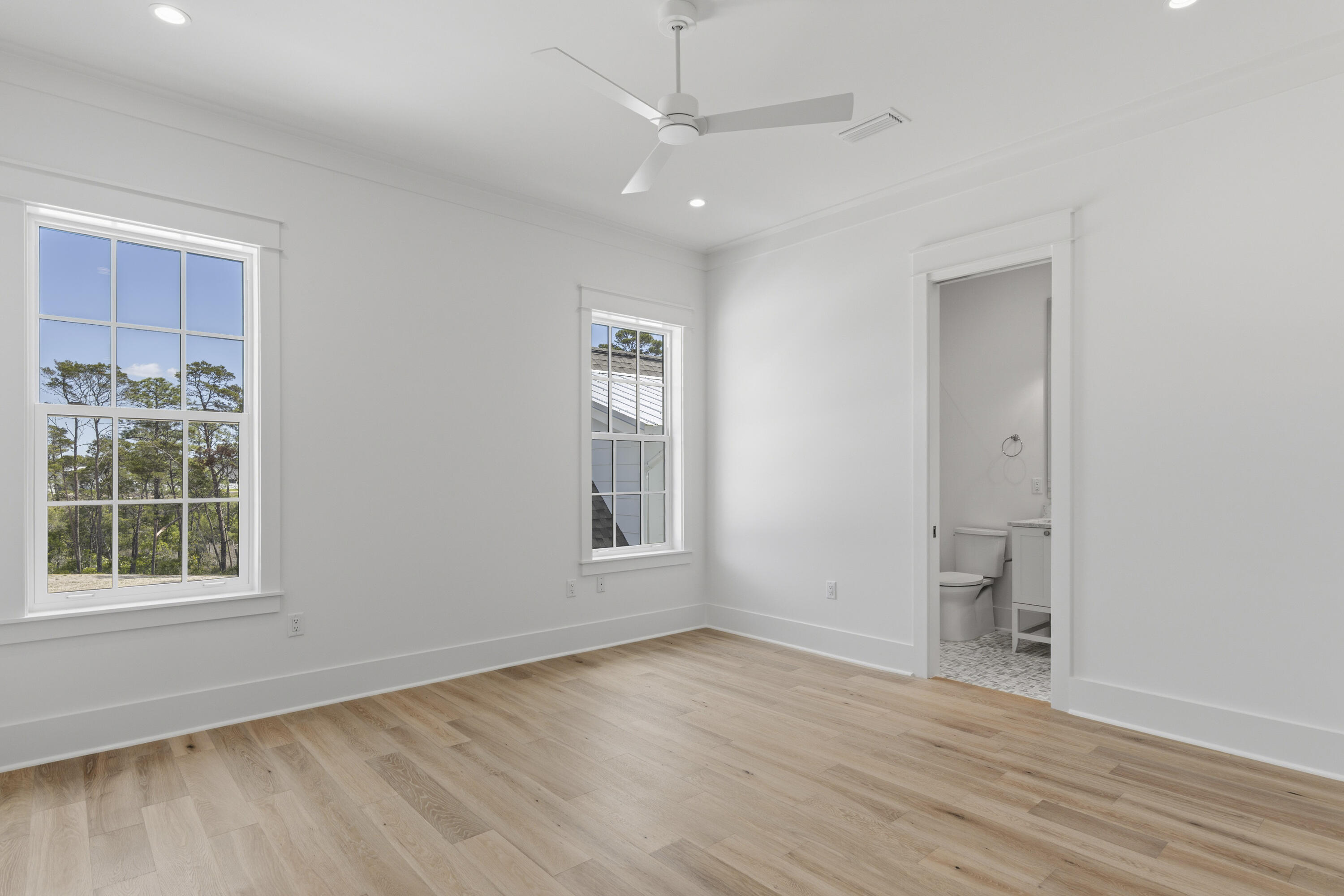 130 East Elliot Way Watersound, FL 32461 - Photo 43 of 52 an empty room with wooden floor and windows