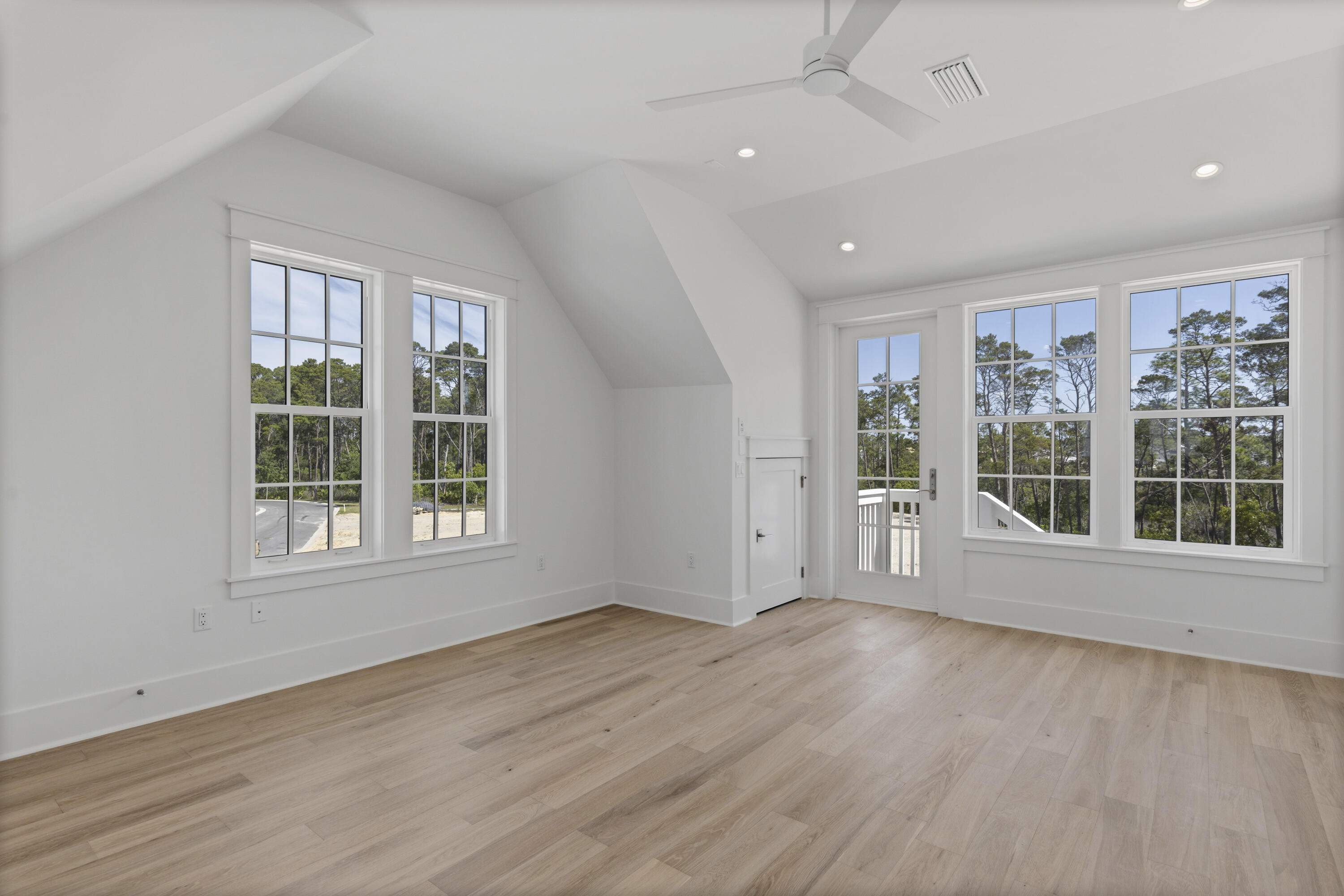 130 East Elliot Way Watersound, FL 32461 - Photo 48 of 52 an empty room with wooden floor and windows