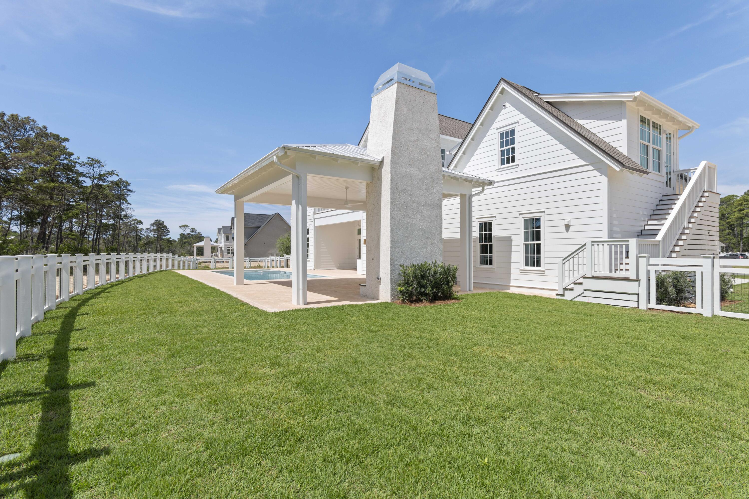 130 East Elliot Way Watersound, FL 32461 - Photo 49 of 52 a view of a house with a yard table and chairs