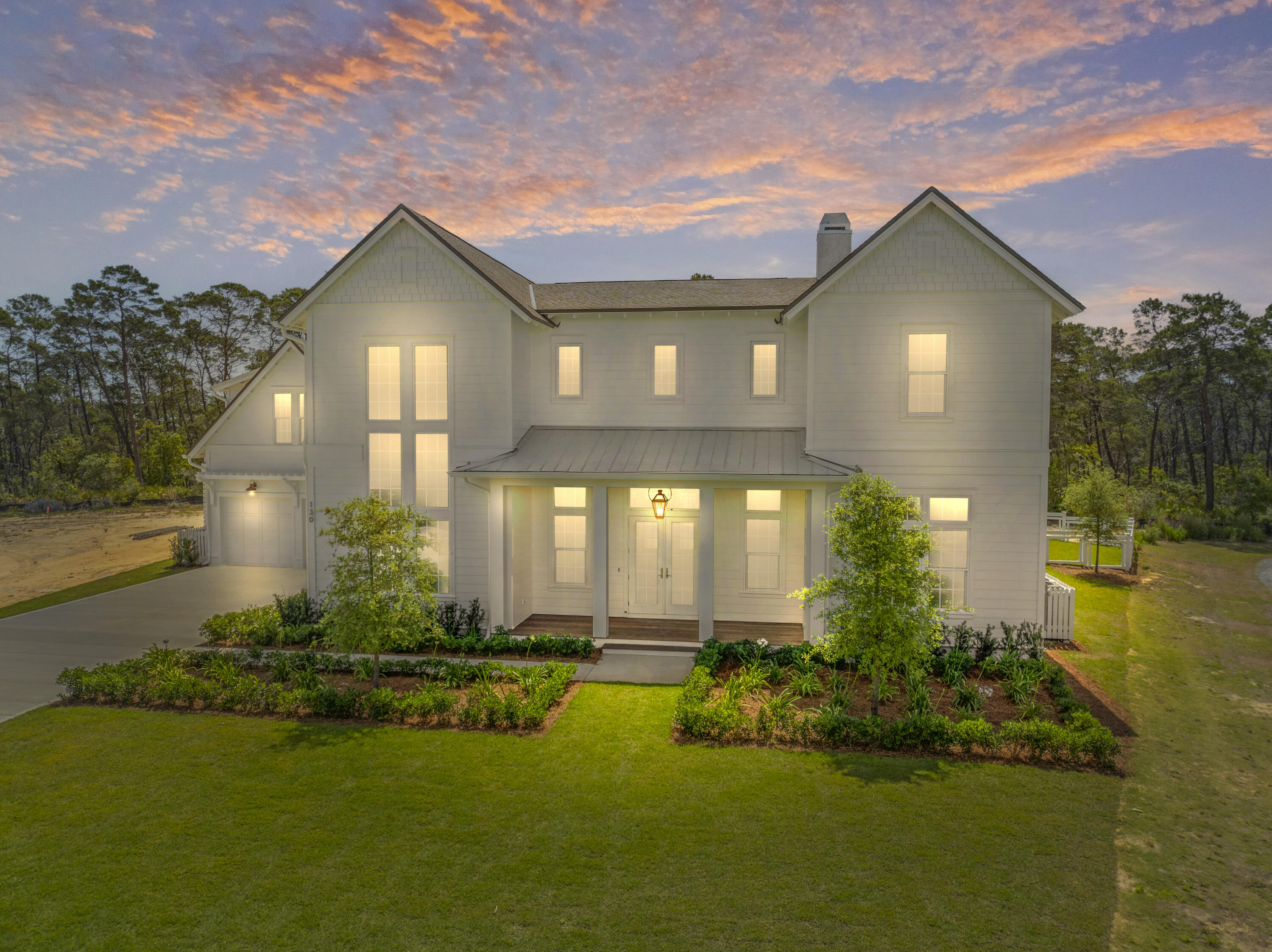 130 East Elliot Way Watersound, FL 32461 - Photo 5 of 52 a front view of a house with a yard and lake view