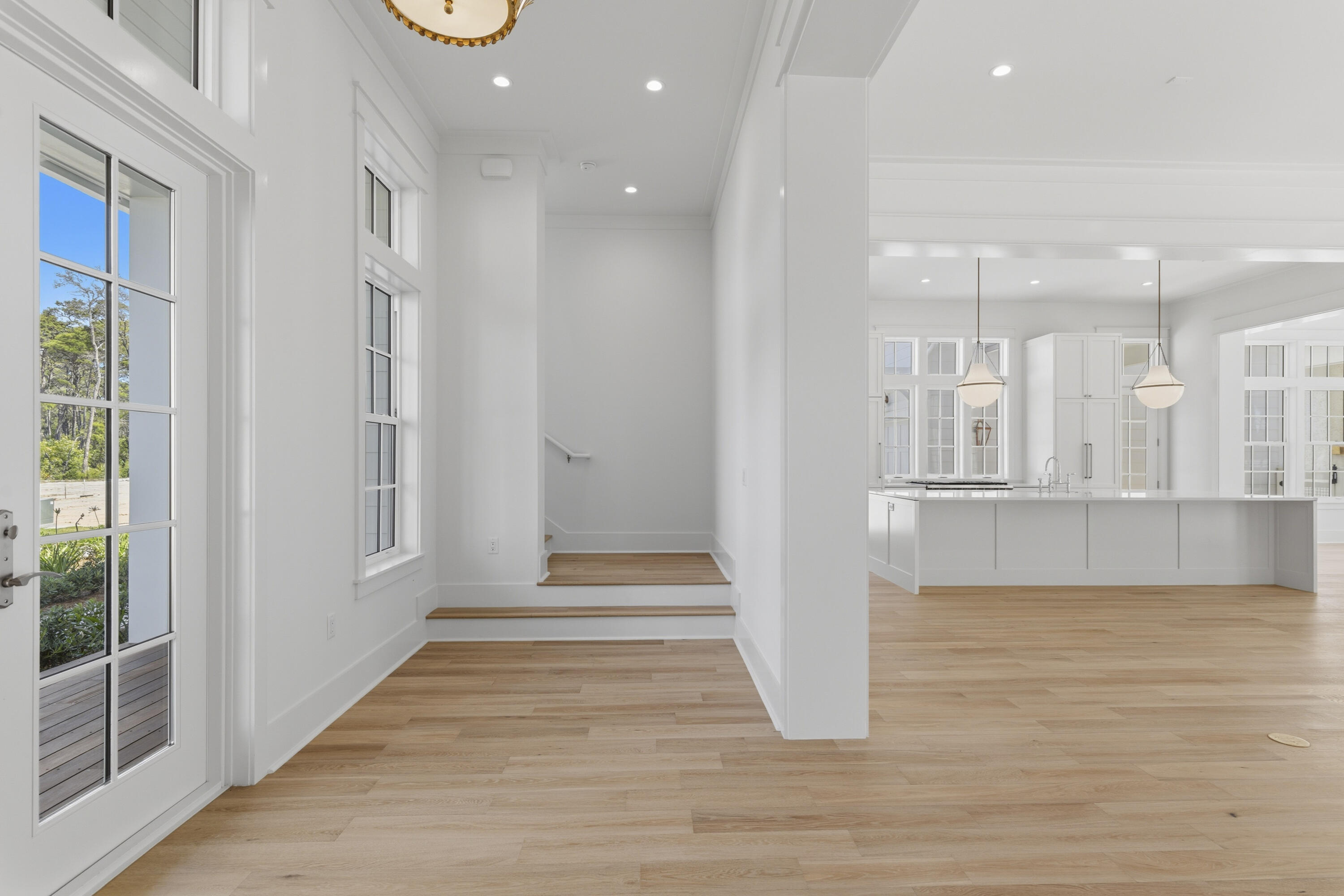 130 East Elliot Way Watersound, FL 32461 - Photo 9 of 52 a view of a hallway with wooden floor and staircase