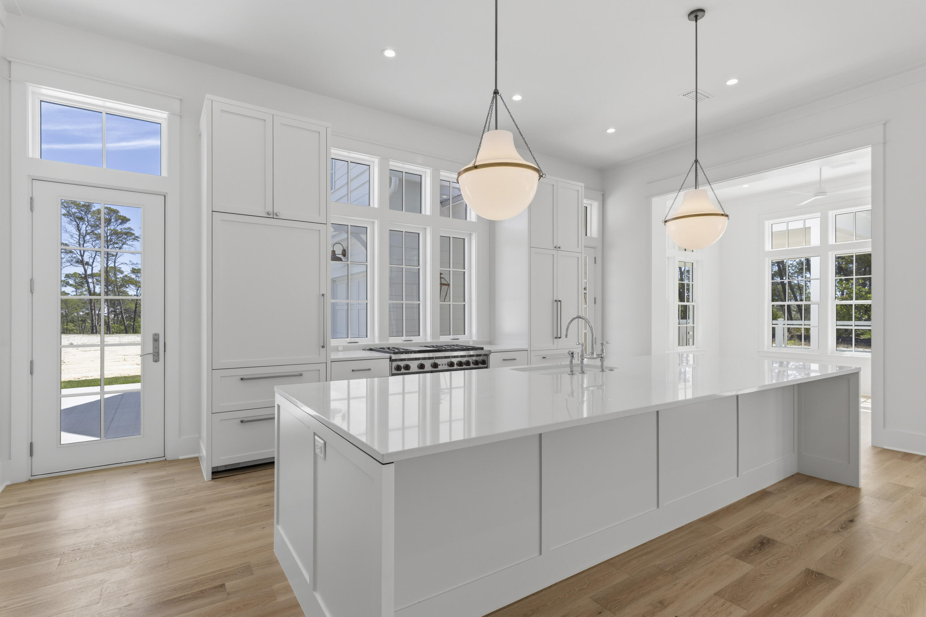 130 East Elliot Way Watersound, FL 32461 - Photo 10 of 52 a open kitchen with white cabinets and chandelier