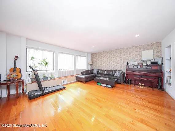 a living room with furniture and a wooden floor