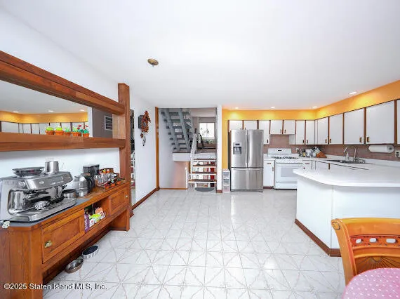 a kitchen with stainless steel appliances kitchen island granite countertop a sink and cabinets