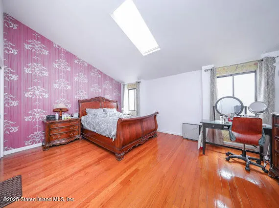 a bedroom with furniture and wooden floor