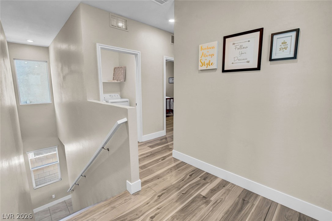 9688 Rankin Rdg Court Las Vegas, NV 89178 - Photo 21 of 53 A well-lit landing showcases diverse flooring and a convenient laundry area.