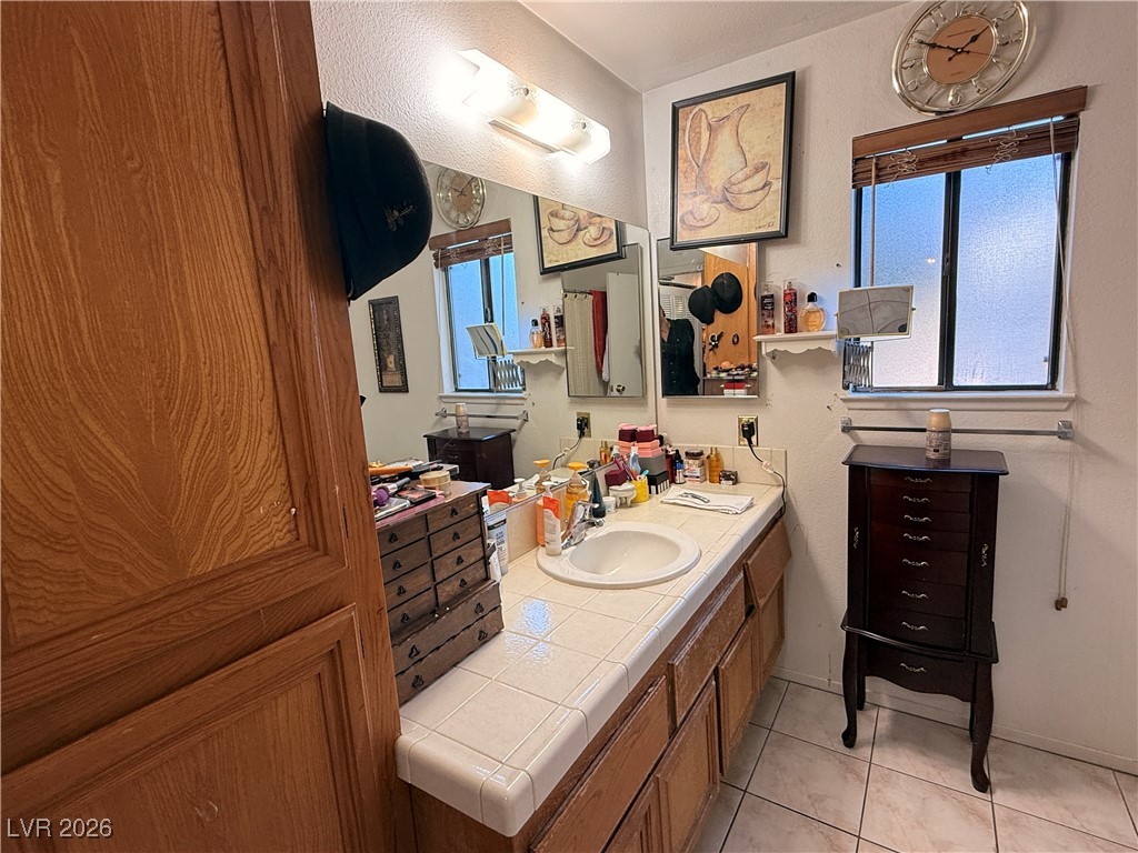6425 West Eagle Point Road Las Vegas, NV 89108 - Photo 13 of 42 Bathroom featuring vanity and light tile patterned flooring