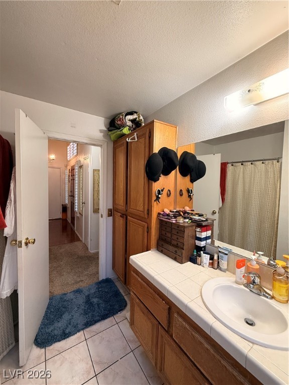 6425 West Eagle Point Road Las Vegas, NV 89108 - Photo 15 of 42 Full bathroom with vanity, a textured ceiling, light tile patterned floors, and curtained shower