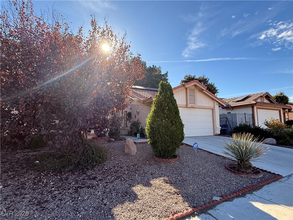 6425 West Eagle Point Road Las Vegas, NV 89108 - Photo 2 of 42 View of front of house featuring driveway, a garage, and a tile roof