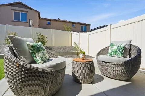 a view of a patio with chair and tables