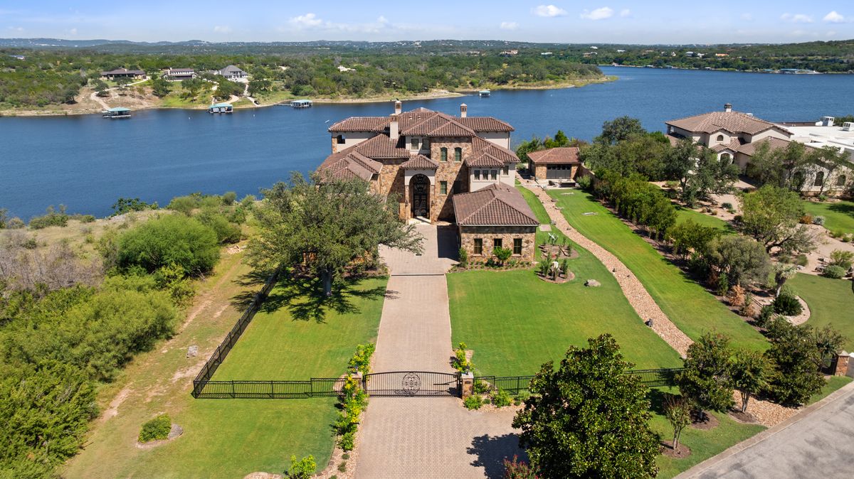 an aerial view of a house with a lake view