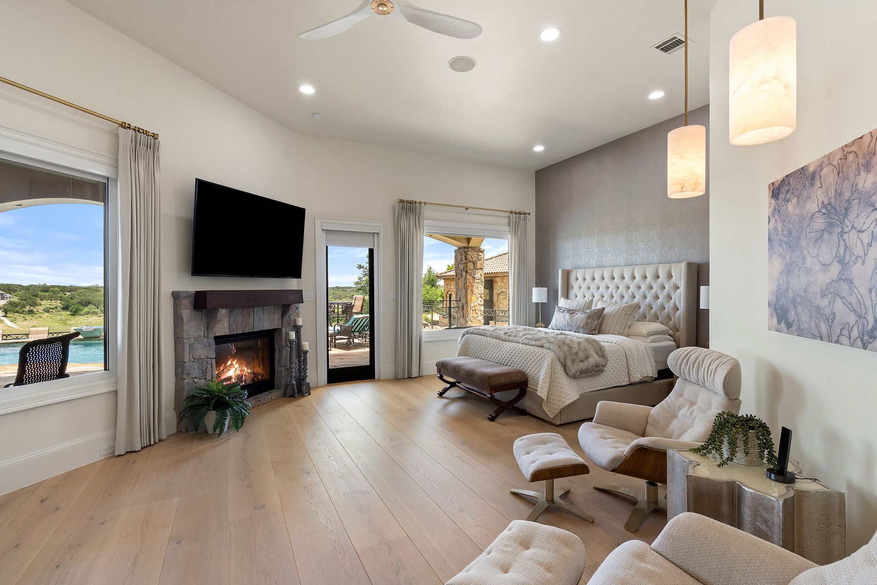 1216 Travis Bluff Way Spicewood, TX 78669 - Photo 15 of 38 a living room with furniture flat screen tv and a fireplace