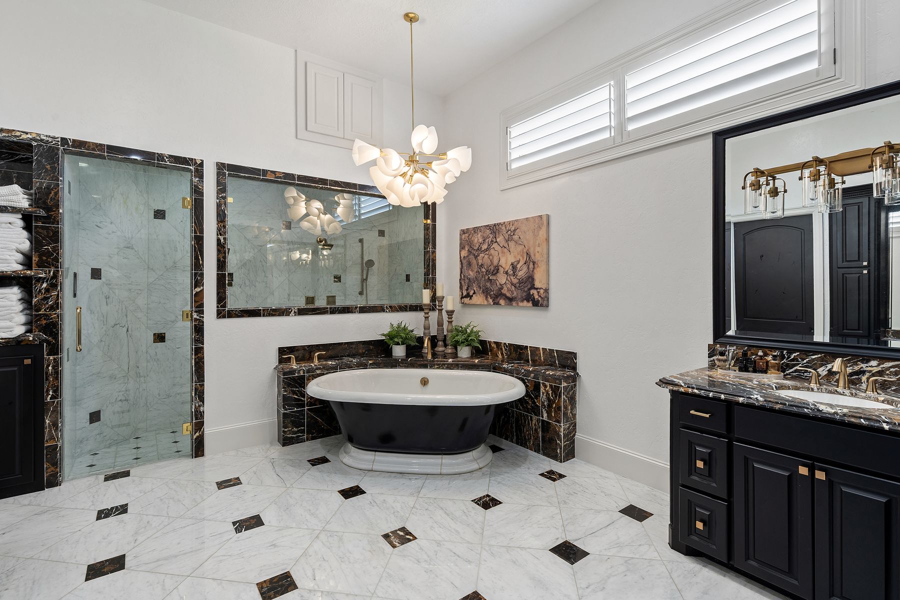1216 Travis Bluff Way Spicewood, TX 78669 - Photo 17 of 38 a bathroom with a sink a mirror and a shower