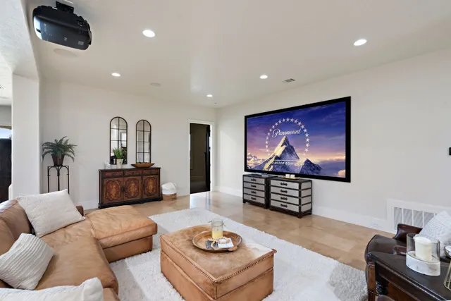 a spacious bedroom with a bed and glass walk in closet