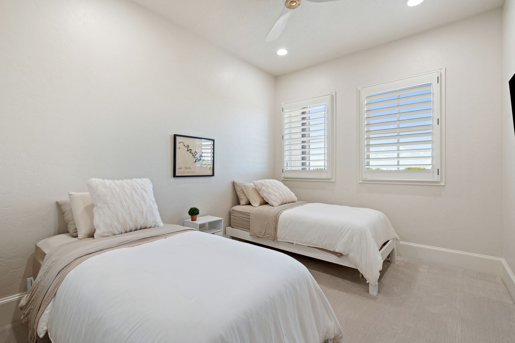 1216 Travis Bluff Way Spicewood, TX 78669 - Photo 27 of 38 a bedroom with two beds and a window