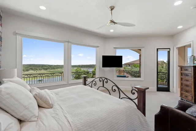 a large white kitchen with a large island