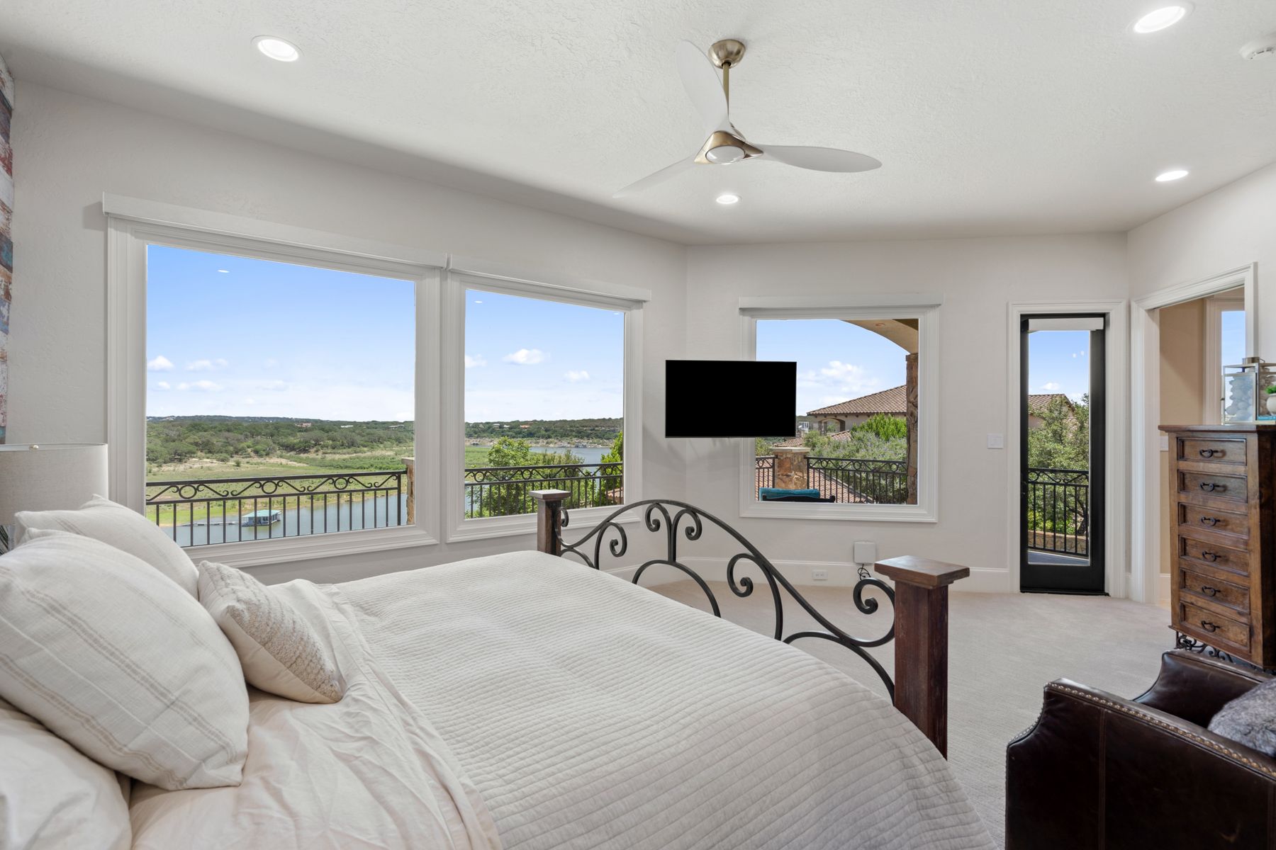 1216 Travis Bluff Way Spicewood, TX 78669 - Photo 32 of 38 a bed room with a bed and a flat screen tv