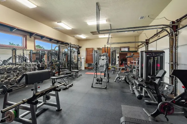 a view of a building with backyard and sitting area