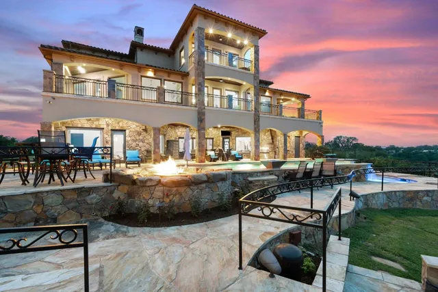 a living room with furniture a flat screen tv and a fountain