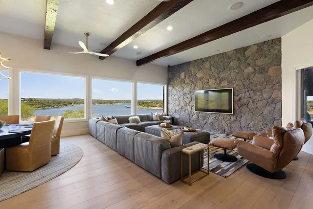 a dining room with furniture and a large window