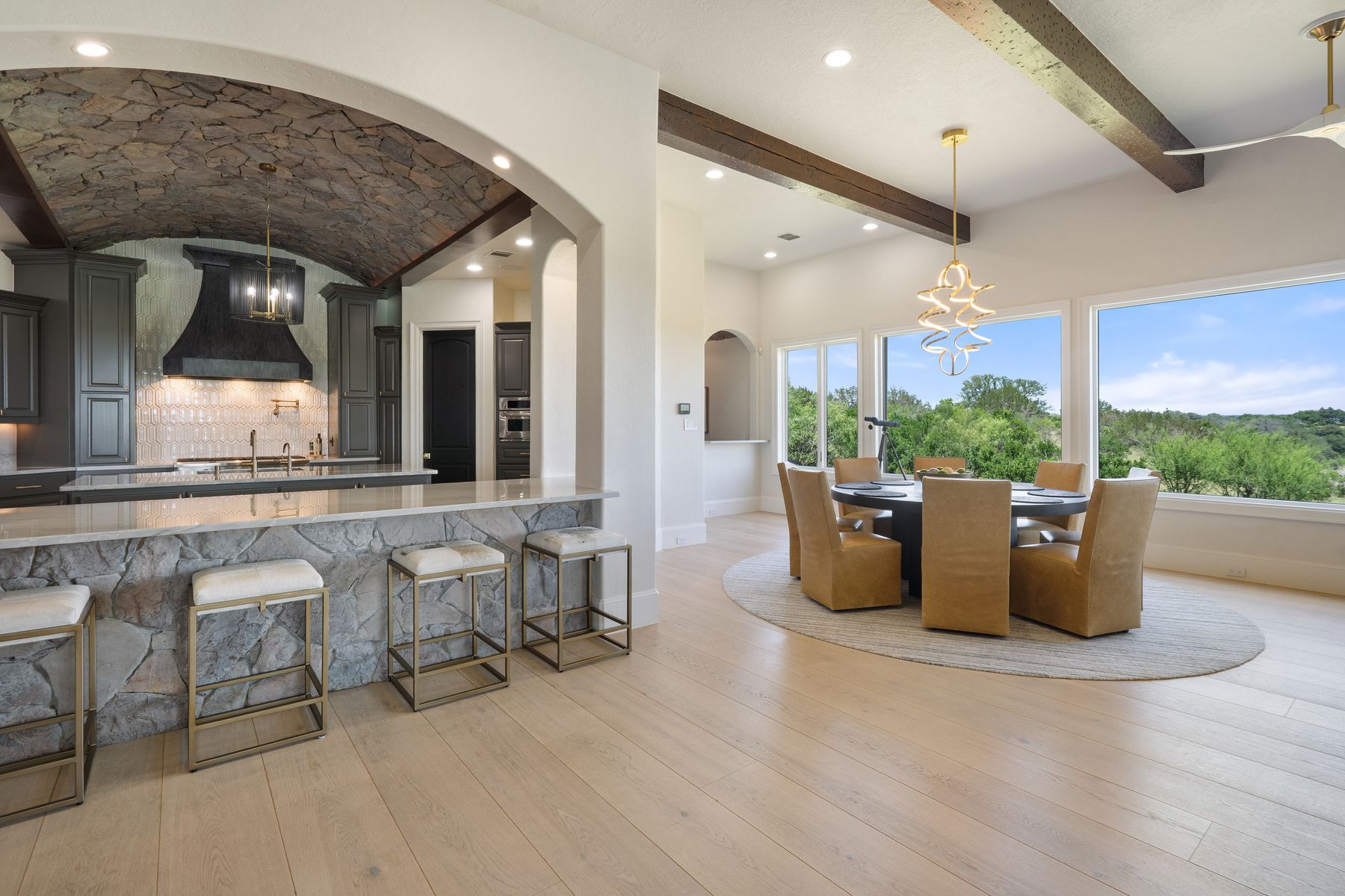 1216 Travis Bluff Way Spicewood, TX 78669 - Photo 10 of 38 a dining room with furniture and a large window