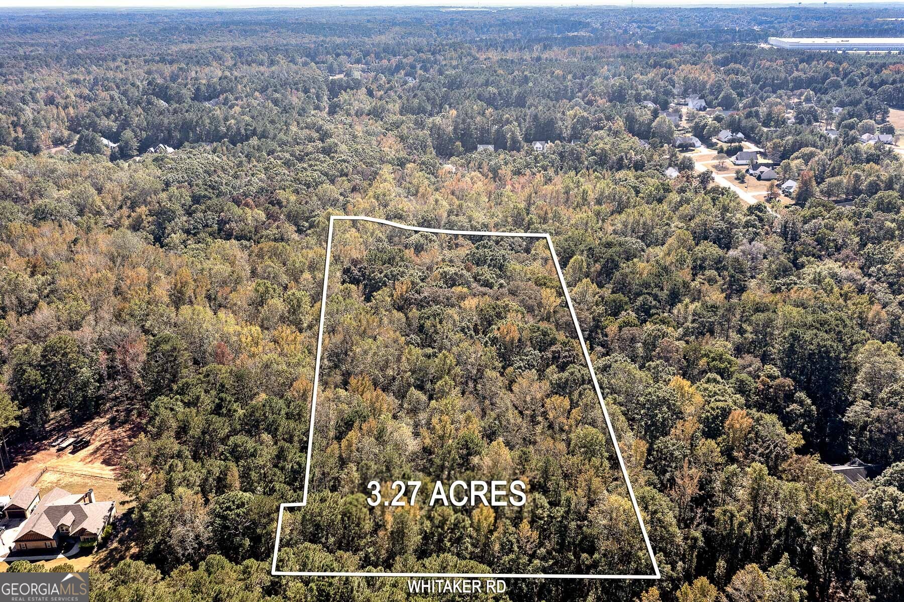 an aerial view of house with yard and mountain view in back