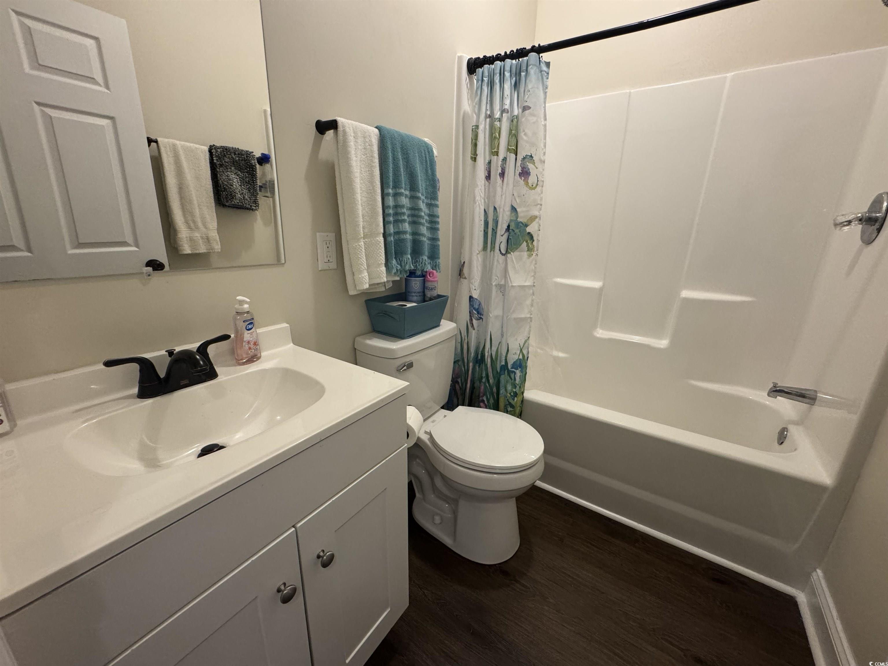304 South Magnolia Avenue Andrews, SC 29510 - Photo 11 of 19 Bathroom featuring wood finished floors, toilet, shower / bath combination with curtain, and vanity