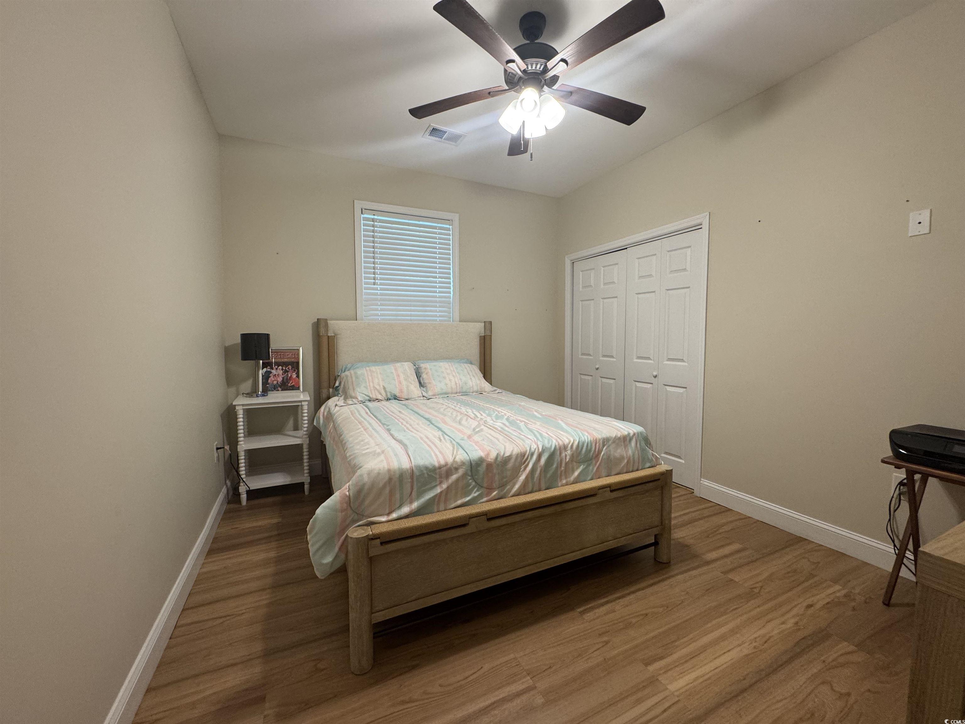 304 South Magnolia Avenue Andrews, SC 29510 - Photo 12 of 19 Bedroom with baseboards, wood finished floors, a closet, and ceiling fan
