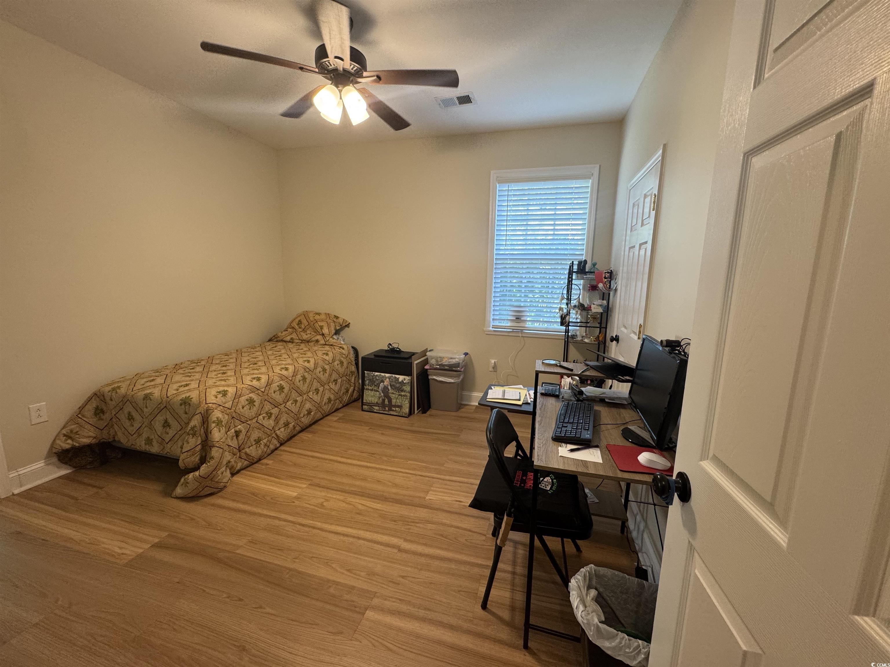 304 South Magnolia Avenue Andrews, SC 29510 - Photo 15 of 19 Bedroom with light wood finished floors, a desk, baseboards, and a ceiling fan